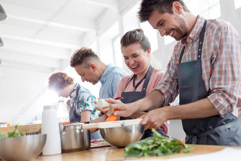 Couple enjoying cooking class in kitchen